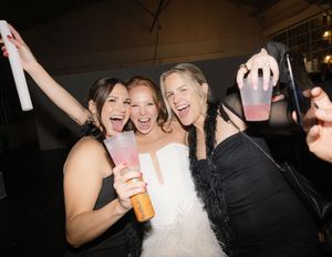 People celebrating and dancing at a lively wedding reception.