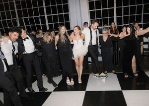 Large industrial wedding venue with guests dancing and mingling on the dance floor.