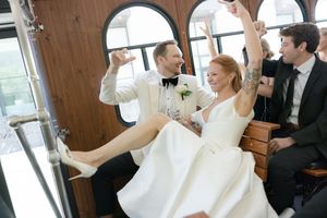 Joyful celebration as newlyweds make a grand entrance at their wedding reception.