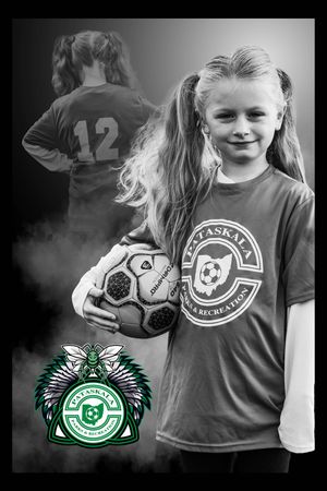 Youth soccer player with number 12 jersey poses with ball in artistic black and white photography.