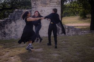 A series of martial arts self-defense training moves being demonstrated outdoors against a stone wall backdrop.