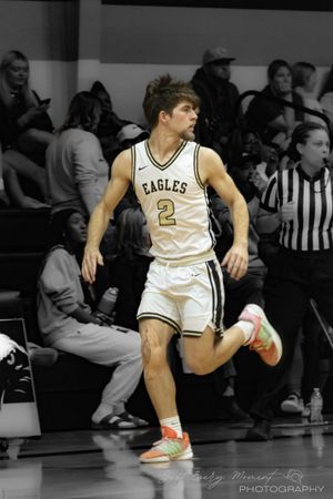 Basketball player in white uniform performs a dynamic dribbling sequence shown in multiple action frames.