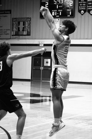 A sequence of black and white basketball action shots showing a player executing a layup move on the court.