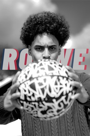A person in a cable knit sweater holds up a white patterned sphere ball with text reading ROOKIE in the background.
