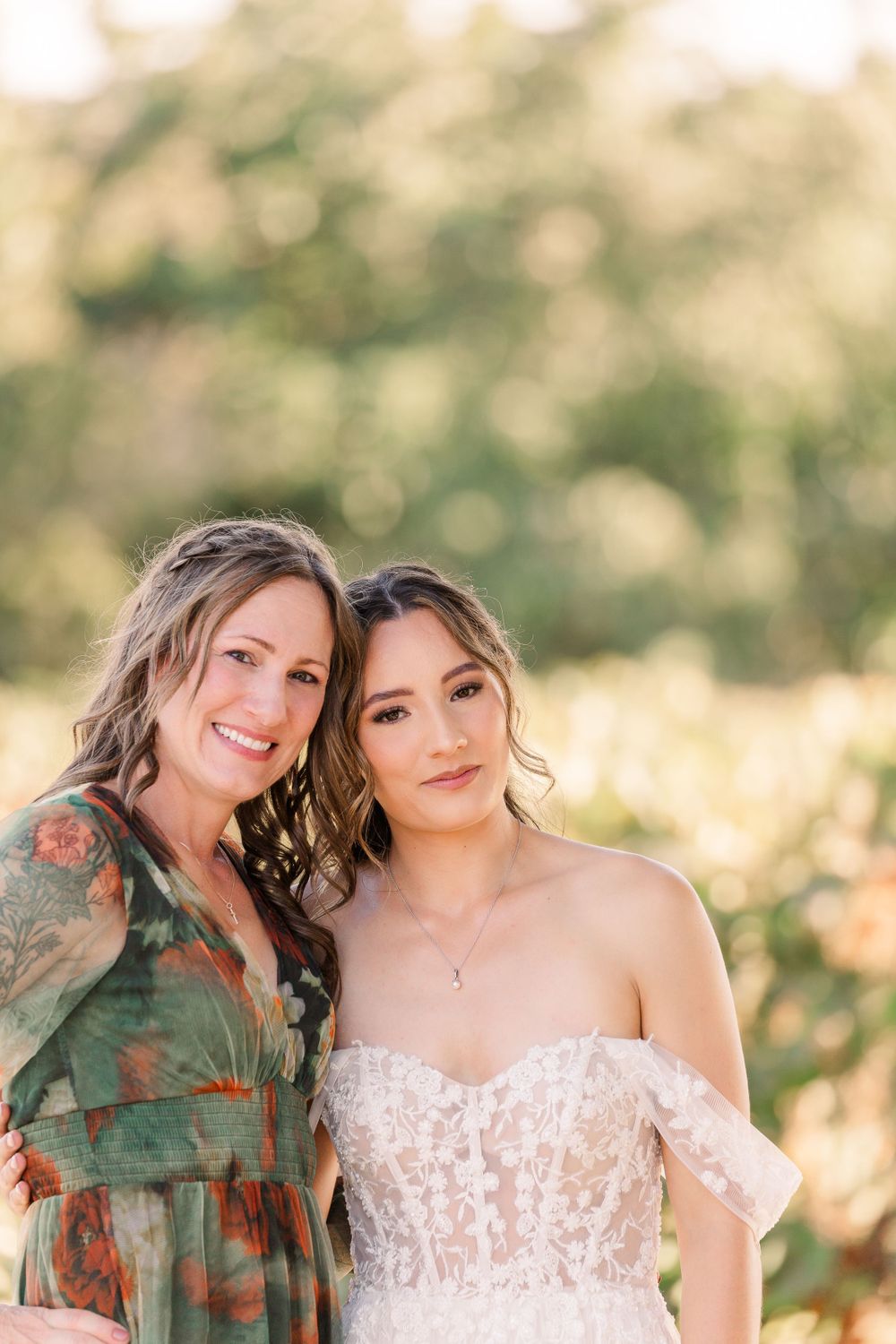 Two people share a close moment together in a sunlit outdoor setting.