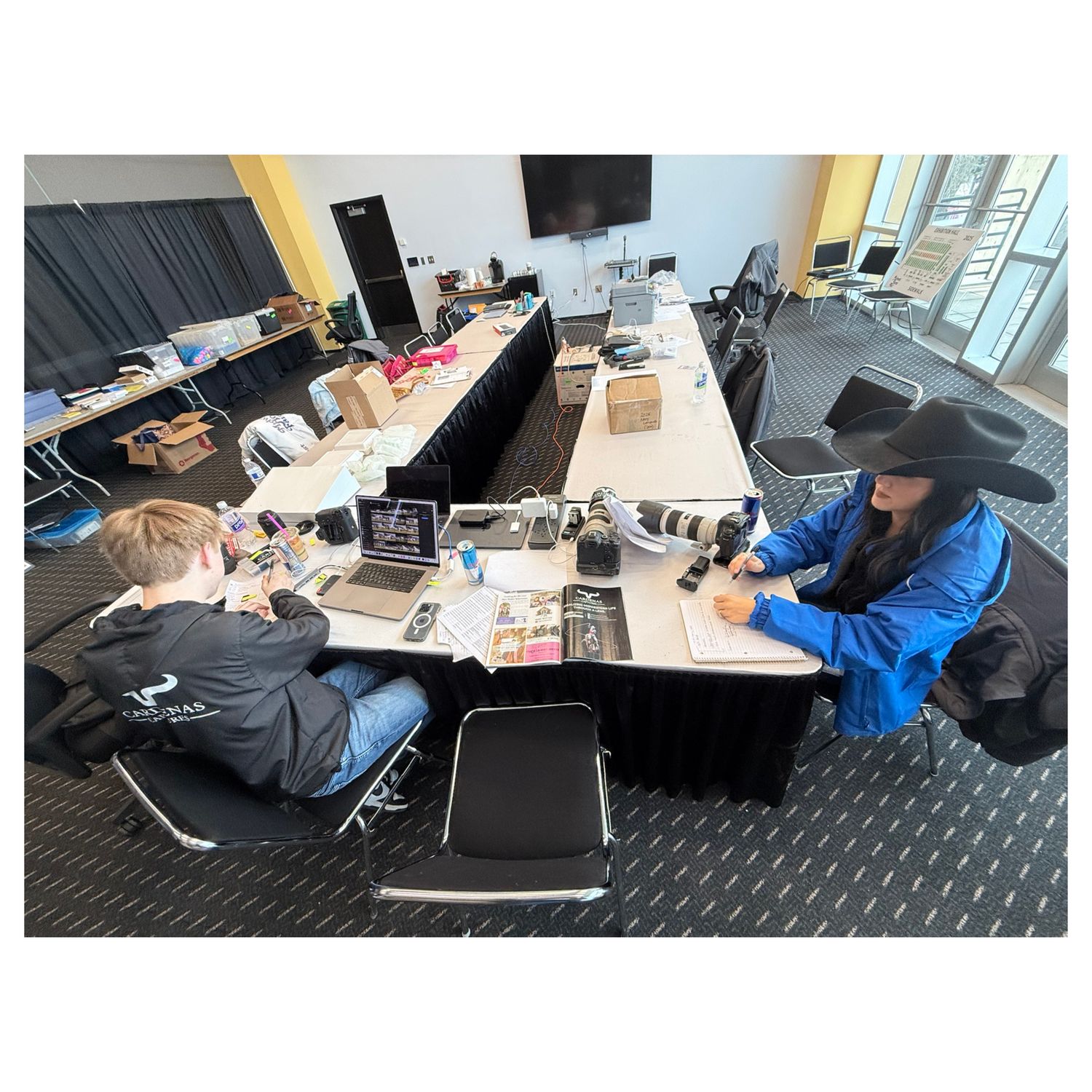 People relaxing on lounge chairs in a modern office space.