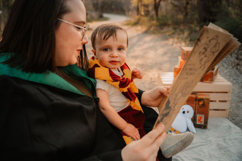 Mother holding baby during Harry Potter–themed session at a Dallas–Fort Worth cake smash photoshoot