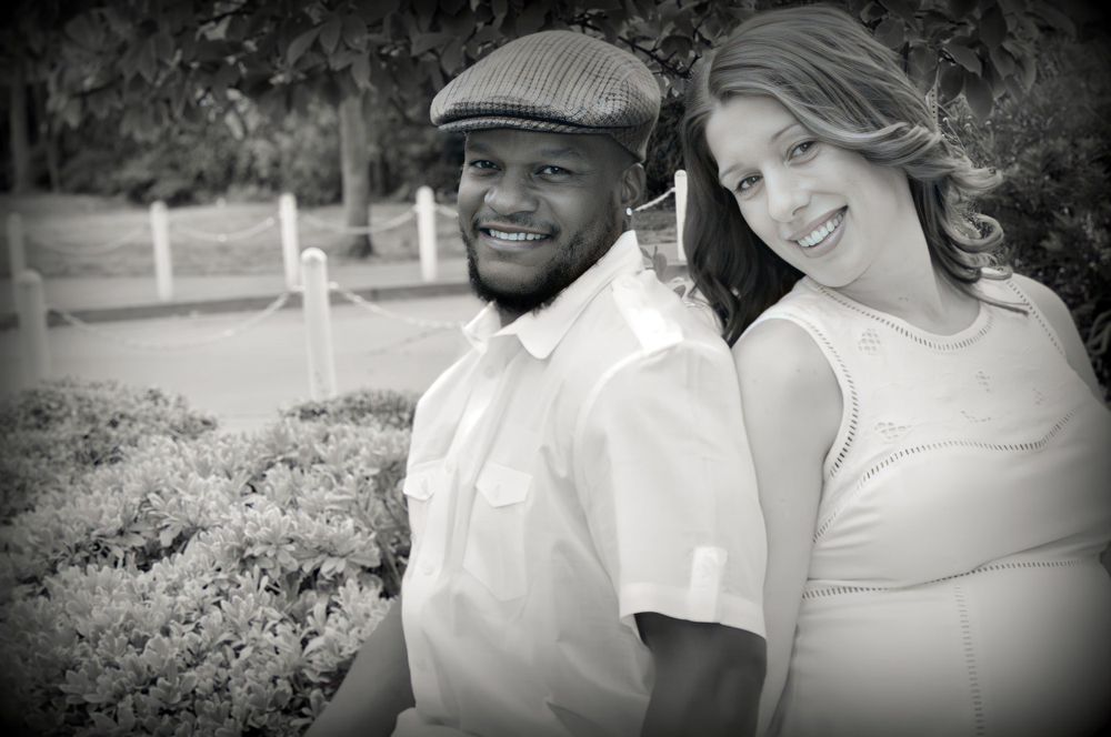 Black and white portrait of couple outdoors in casual attire.