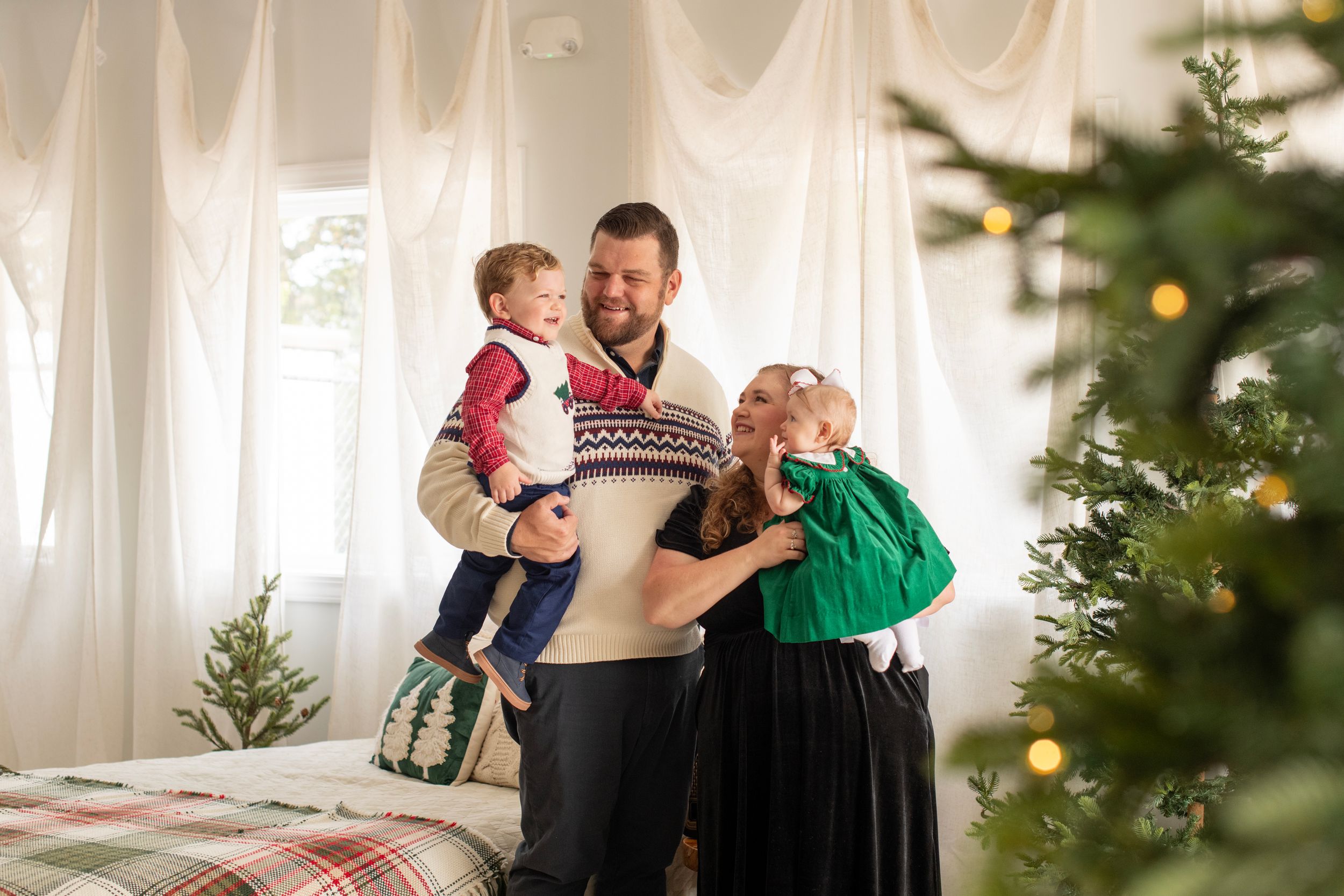 Family laughing together at Christmas Minis at Joyride Social Studio in Lexington, SC.
