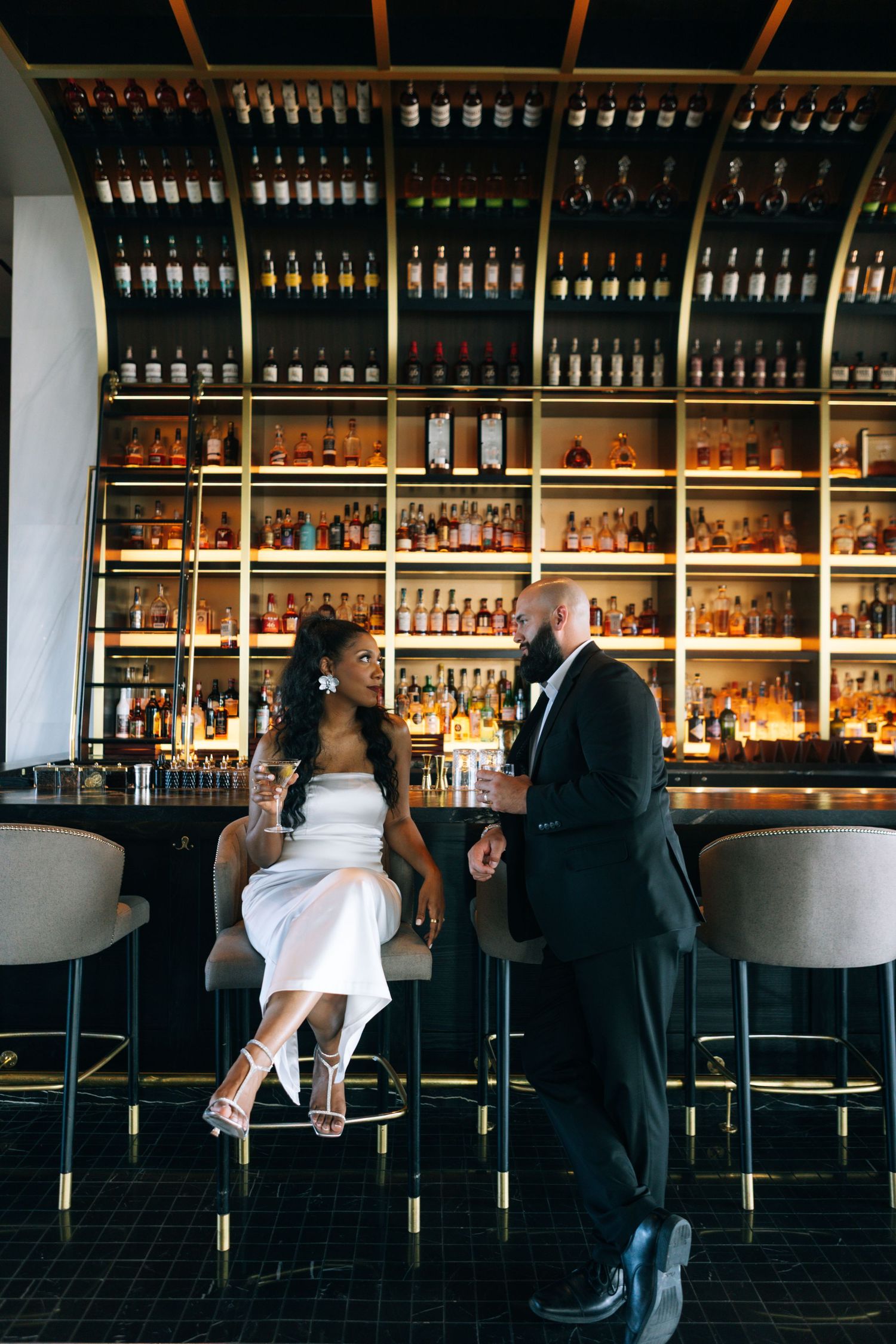 Stylish bar scene with couple at counter showing progression of romantic interaction.
