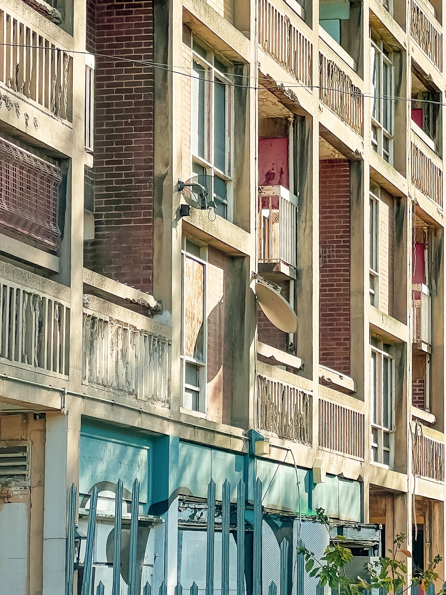 Park Hill Flats, Sheffield. Aging apartment block facade with concrete textures, worn paint and balcony details.