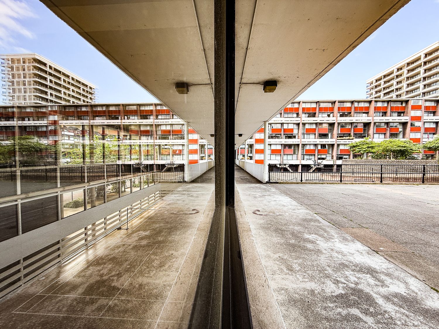 Golden lane estate.  Aging apartment block facade with concrete textures, worn paint and balcony details.