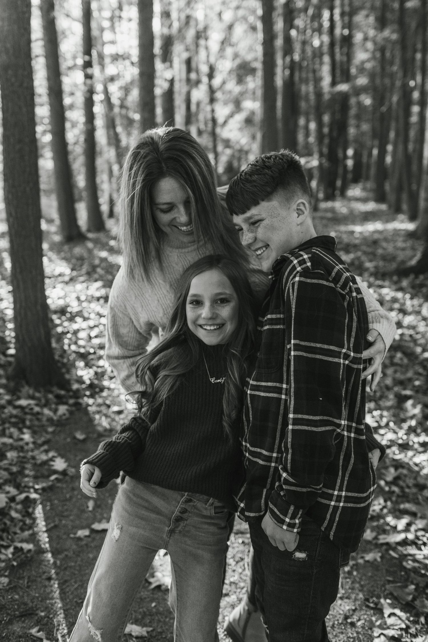 Couple sharing a joyful embrace during golden hour in casual fall attire.