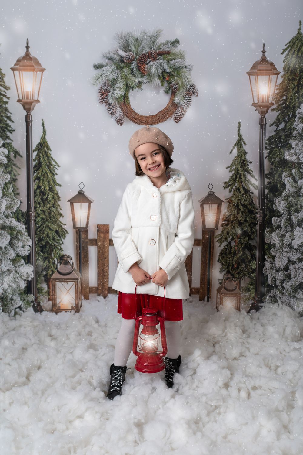 Winter scene with lantern posts and evergreen decorations set against snowy backdrop with festive holiday styling.