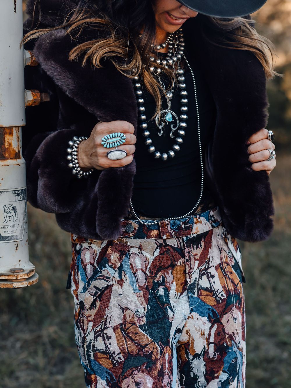 Bohemian winter outfit with fur jacket, turquoise jewelry and printed pants.