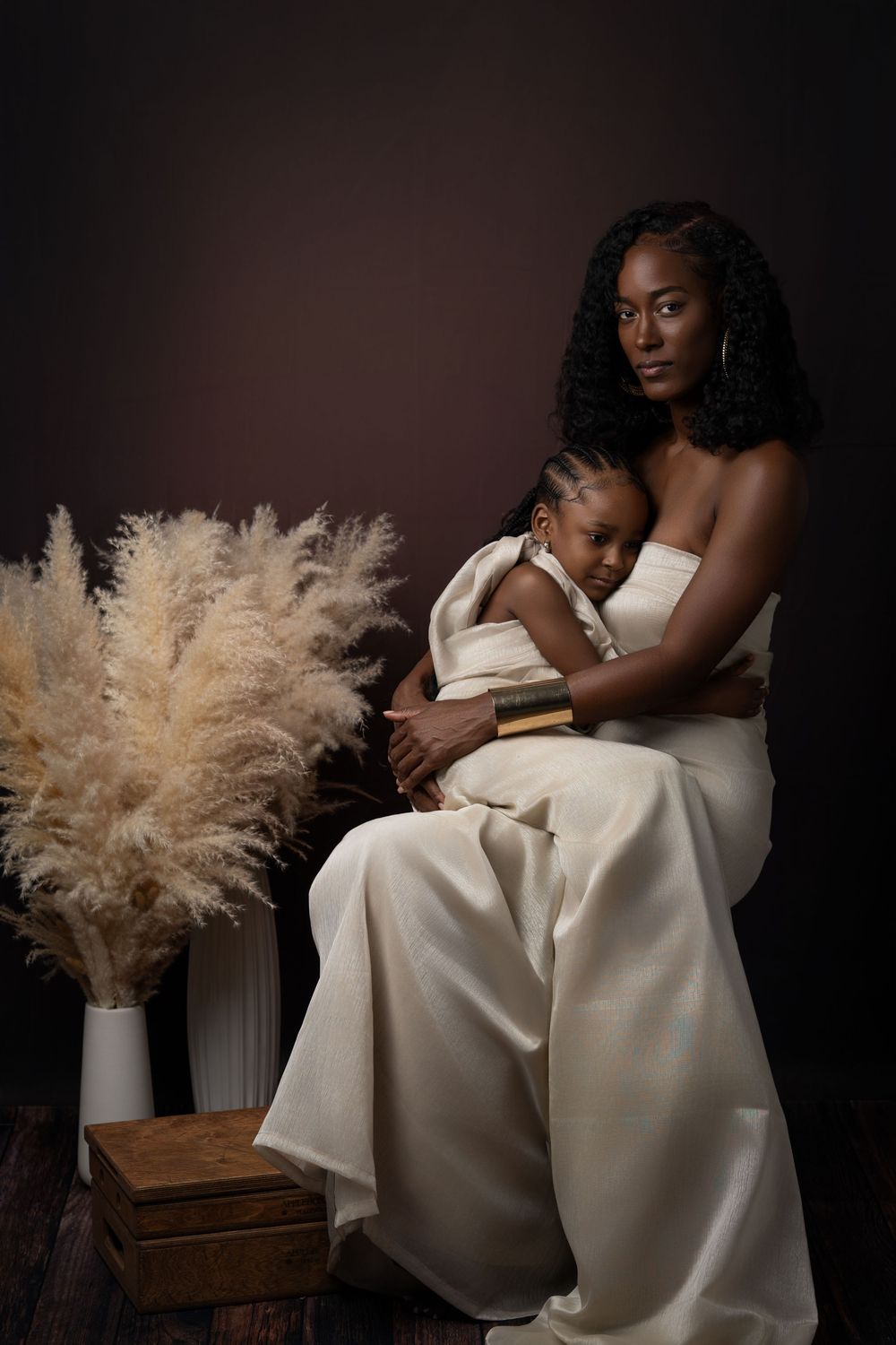 Elegant artistic series of black and white photographs showing figures in white dresses with pampas grass decor.