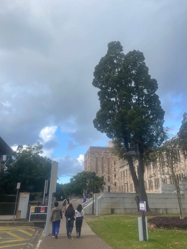 Wide shots of a historic stone building complex with walkways and trees.