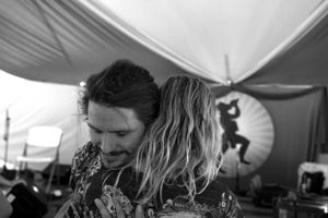Black and white candid shot of participants during an intimate moment at an event.