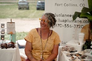 Vendor booth displaying handmade jewelry and crafts at an outdoor market in Fort Collins.