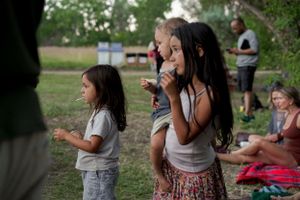 People enjoy music and dancing at an outdoor summer gathering.