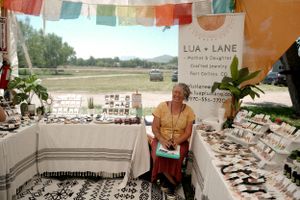 Artisan display booth with colorful prayer flags and handmade jewelry collections.