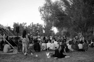 Black and white photo of a crowd gathered on a hillside for an outdoor event.