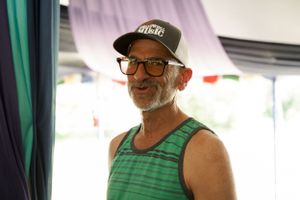A candid moment at an outdoor event under a tent canopy.
