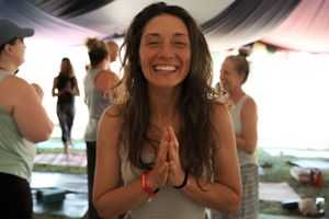 A candid moment of meditation and joy at an outdoor wellness event.