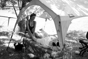 A shaded canopy tent provides respite on a warm afternoon in nature.