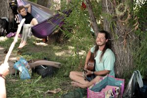 People sitting and relaxing in a shaded outdoor garden area.