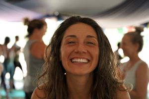 A joyful expression captured during a wellness gathering under a tent.
