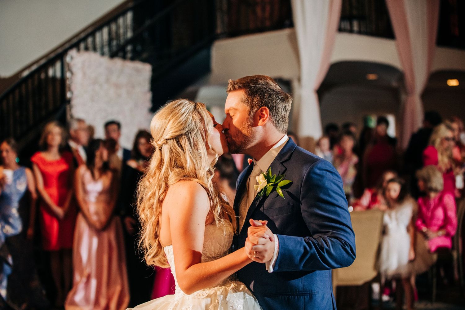 A tender first dance moment shared by a couple during their wedding reception on the dance floor.