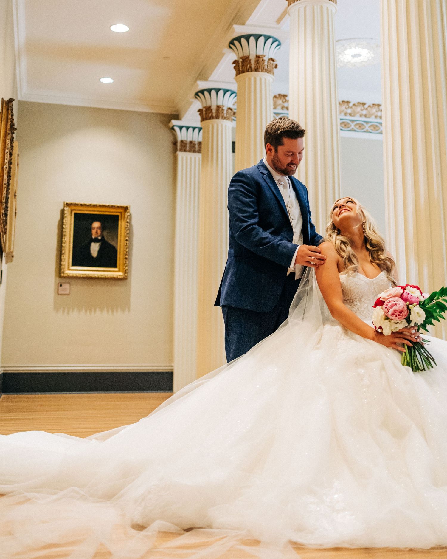 Romantic wedding couple sharing an intimate dip during their first dance in an elegant ballroom.