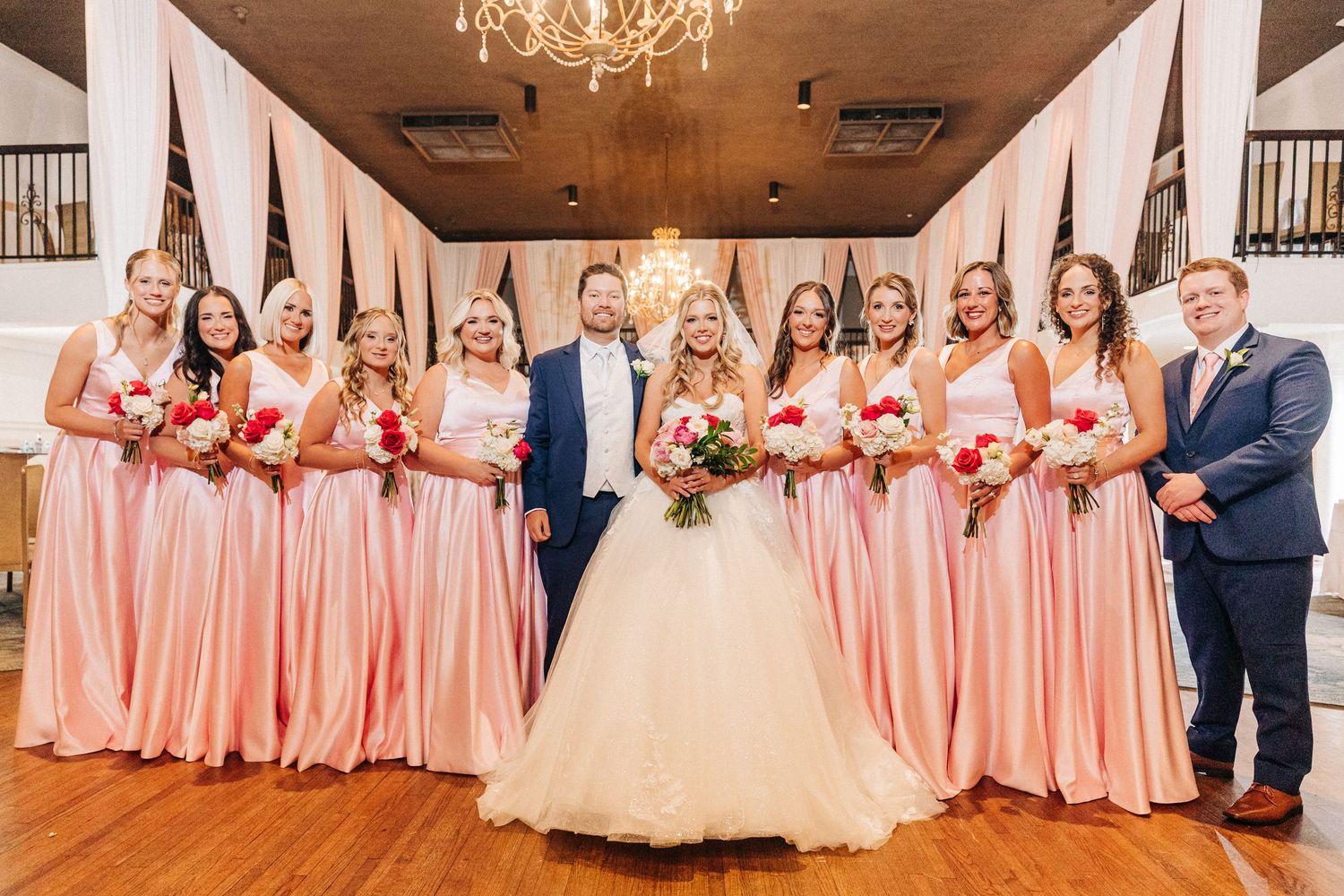 A panoramic collage of wedding party photos showing bridesmaids in coral dresses and groomsmen in navy suits at a reception.