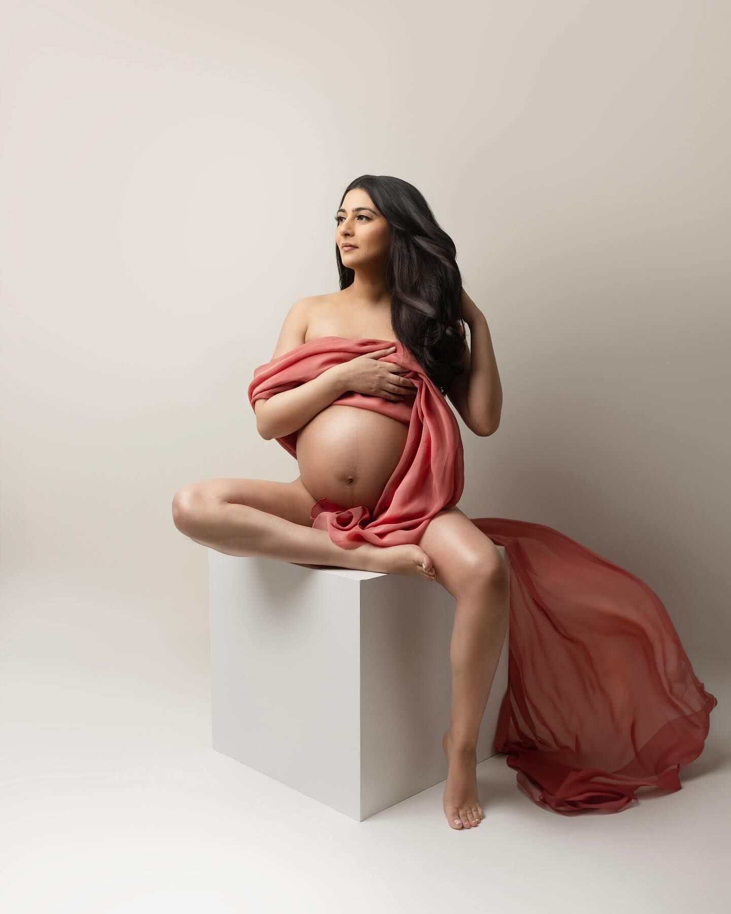 pink silk fabric at your maternity session to signify a baby girl.