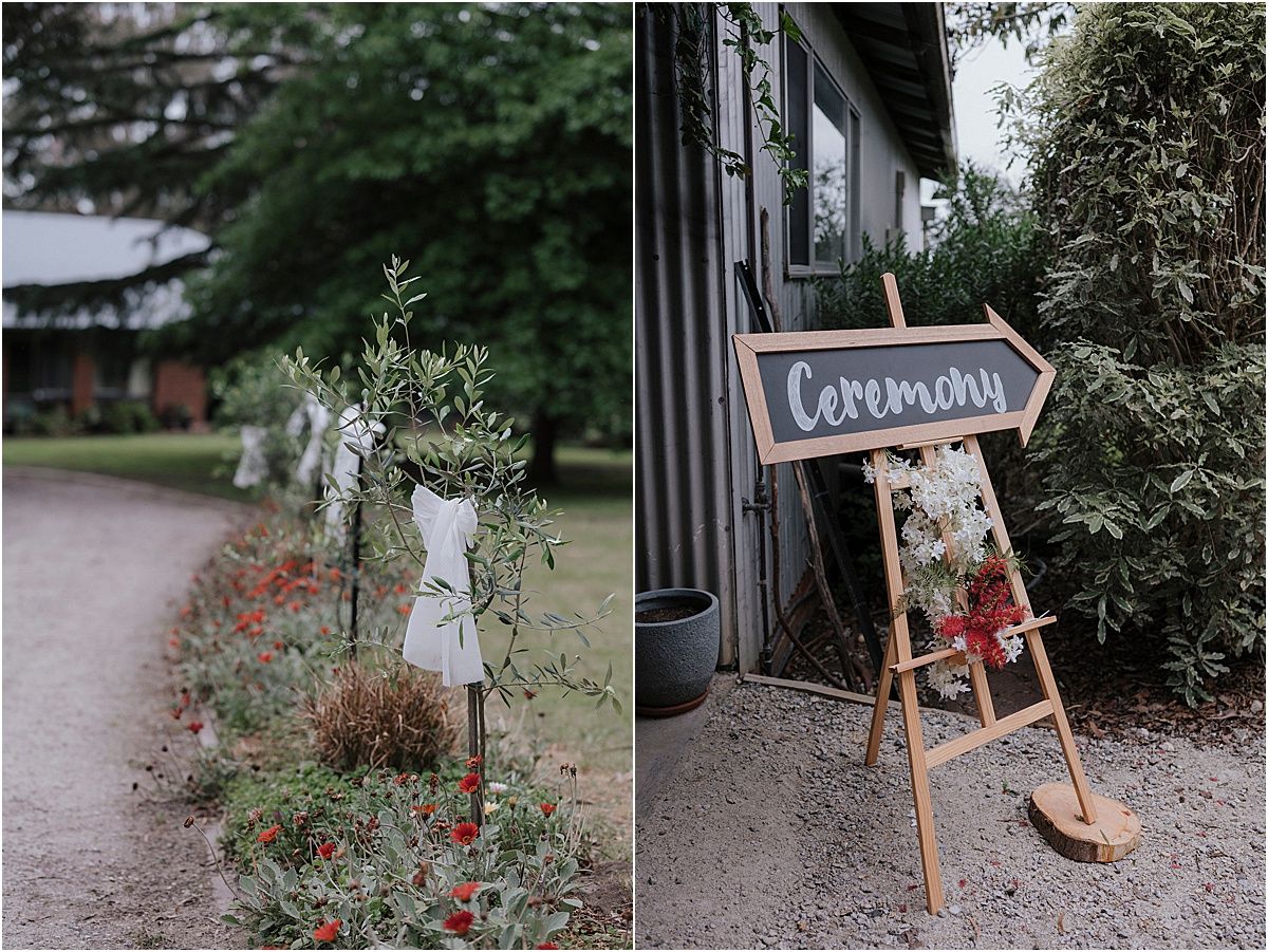 Rustic wedding ceremony signage and decorations in an outdoor garden setting.