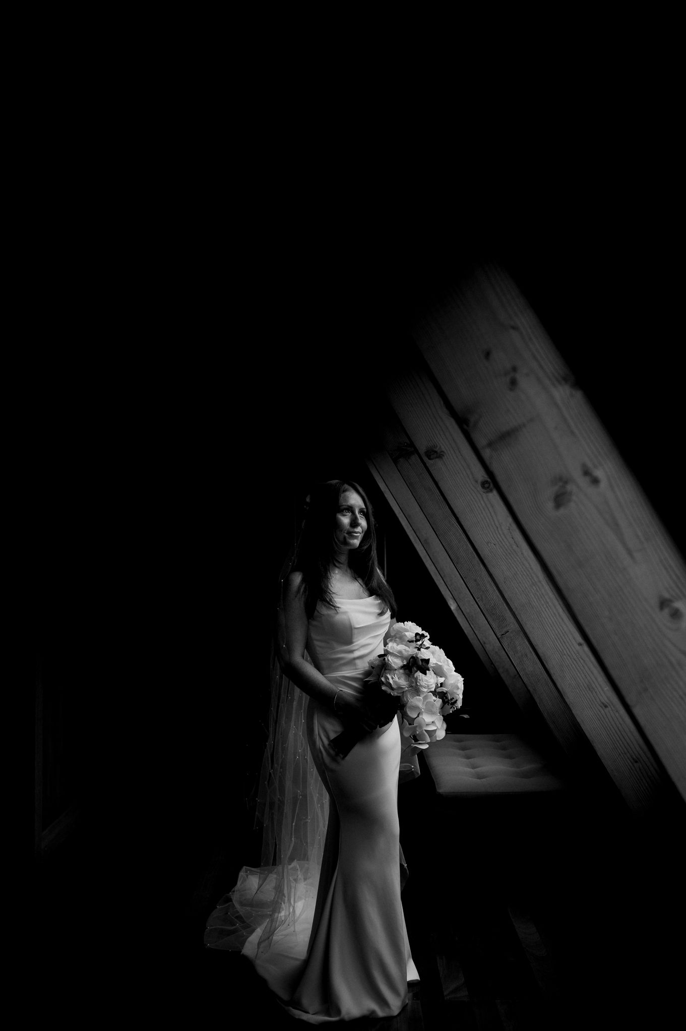 Dramatic black and white bridal portrait in moody lighting.