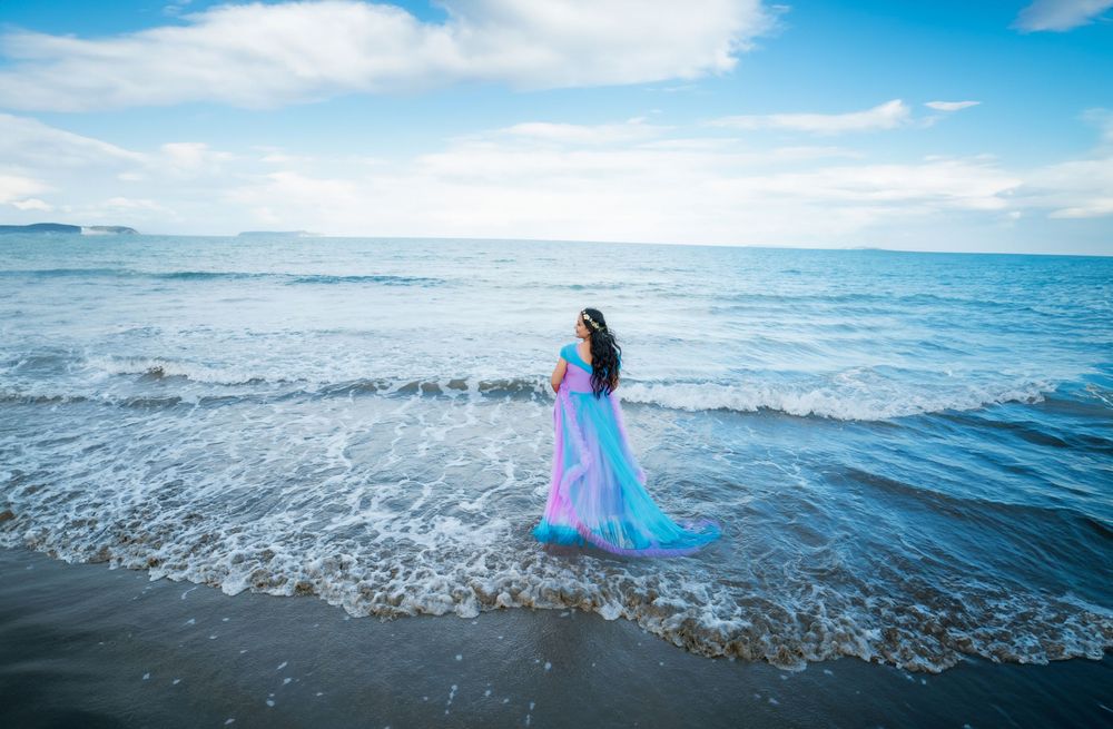 A panoramic sequence showing a bright blue fabric flowing and dancing in ocean waves against a sunny sky.