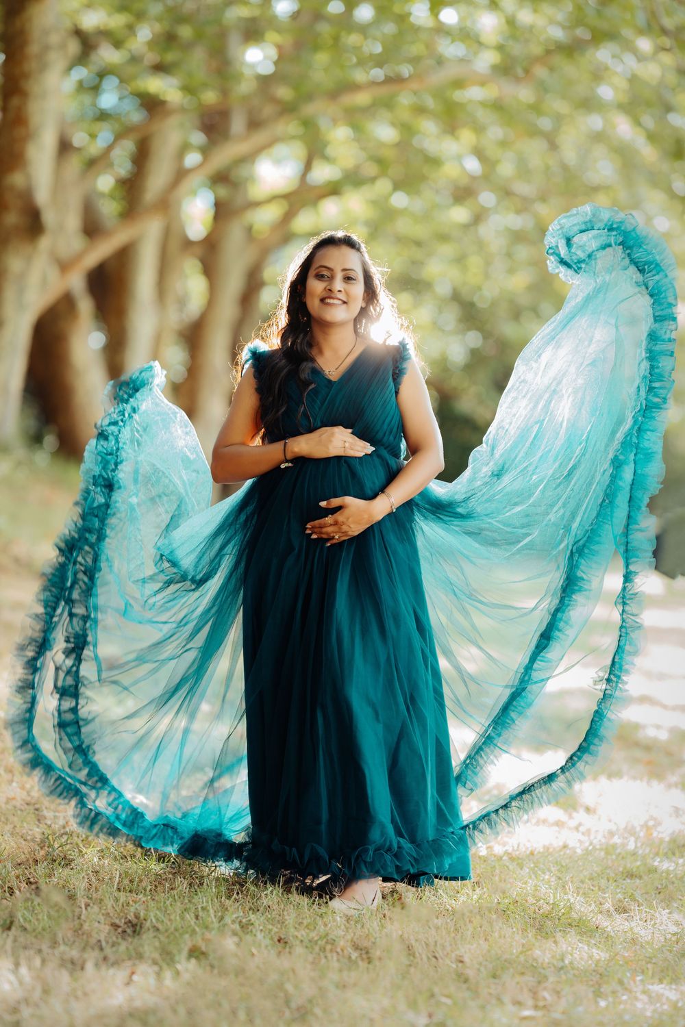 A person in a dark blue dress spins gracefully, showing off layers of turquoise ruffled petticoats beneath.