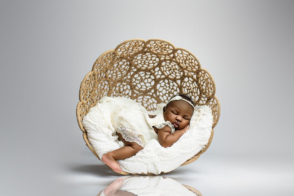 Award-winning newborn photographer Brisbane – baby sleeping in sculptural nest chair, professional studio portraits Springfield Lakes near I