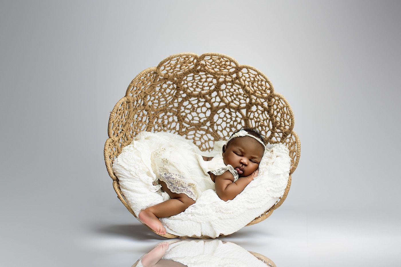 Award-winning newborn photographer Brisbane – baby sleeping in sculptural nest chair, professional studio portraits Springfield Lakes near I