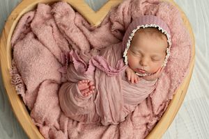 baby bonnie all wraped up in pink, positioned in a heart shaped bowl, prop photographer, brisbane ipswich, maternity, pregnancy.