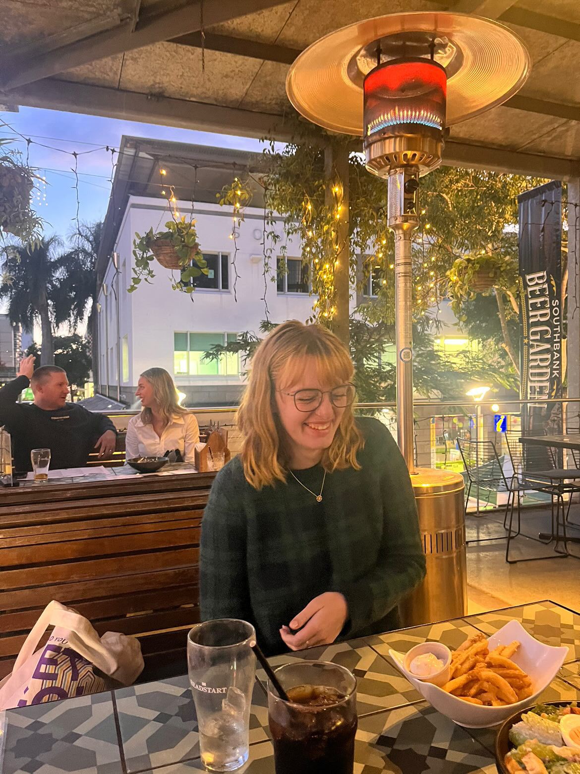 People seated at a restaurant table with french fries and drinks visible across multiple candid dining moments.