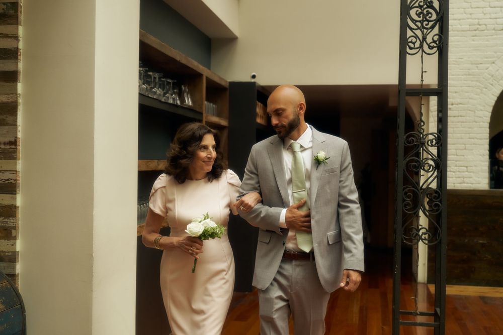 A couple shares their first dance at their wedding reception in a brick wall venue with romantic lighting at the Milling Room