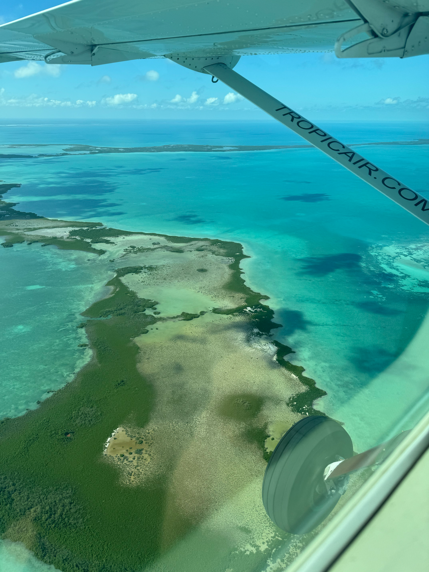 Aerial view of tropical islands and coral reefs surrounded by turquoise waters.