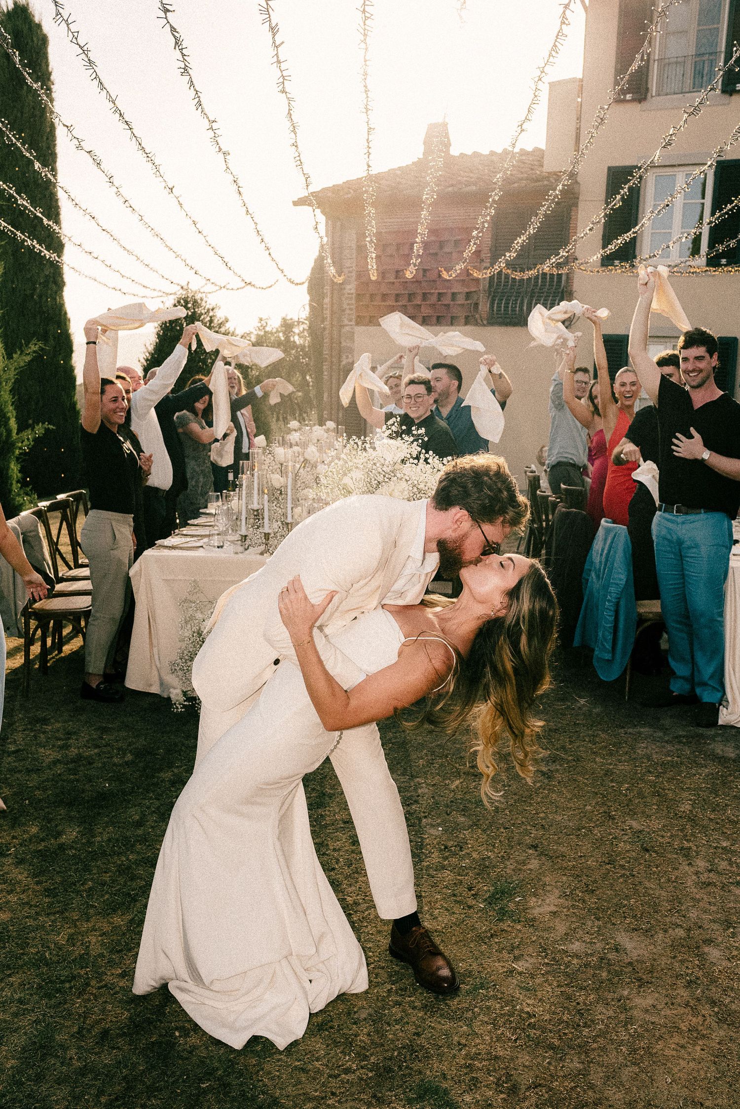 Four romantic dance moments during an outdoor wedding celebration under a white tent at sunset.