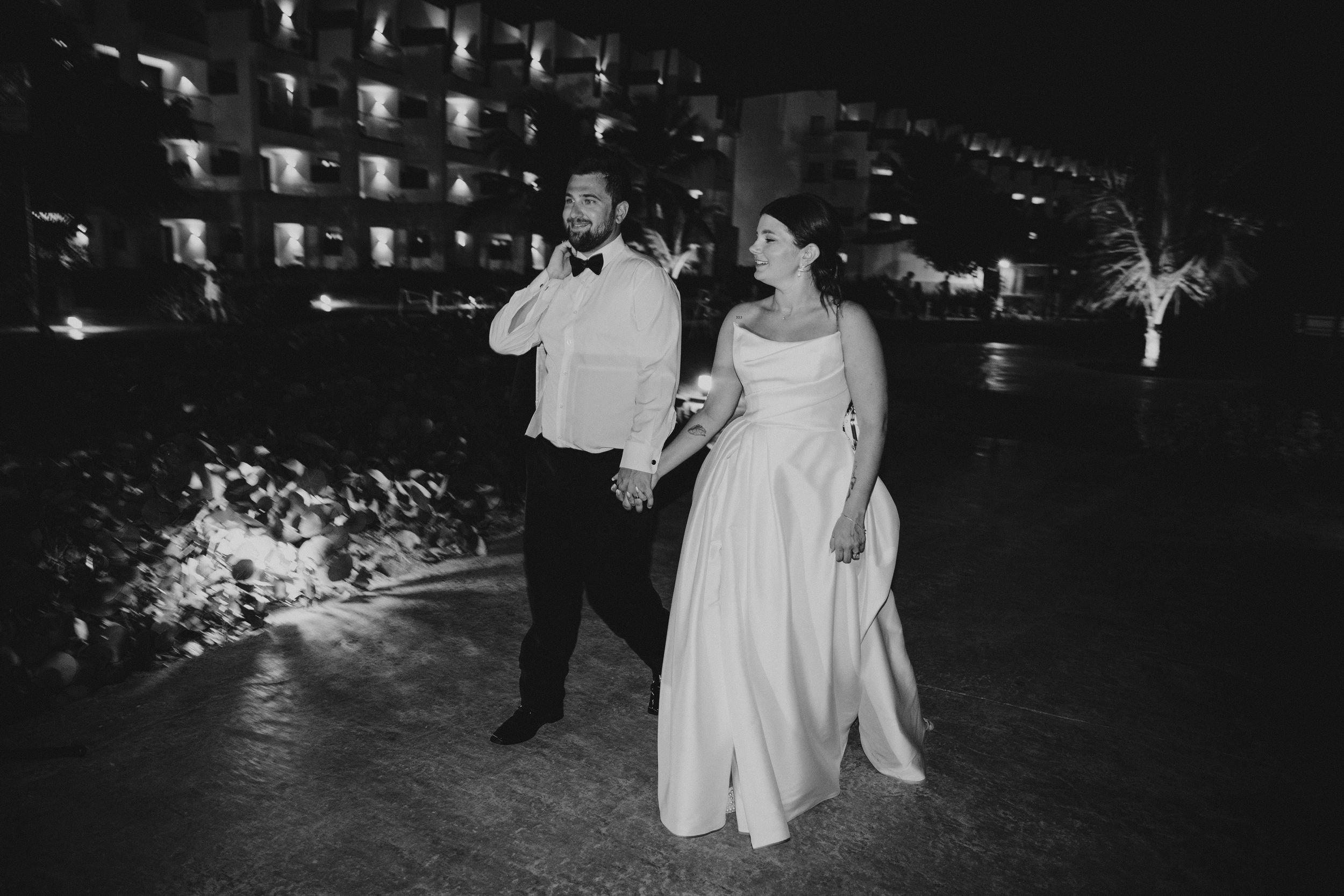 Nighttime wedding reception with string lights creating a magical atmosphere for dancing guests.