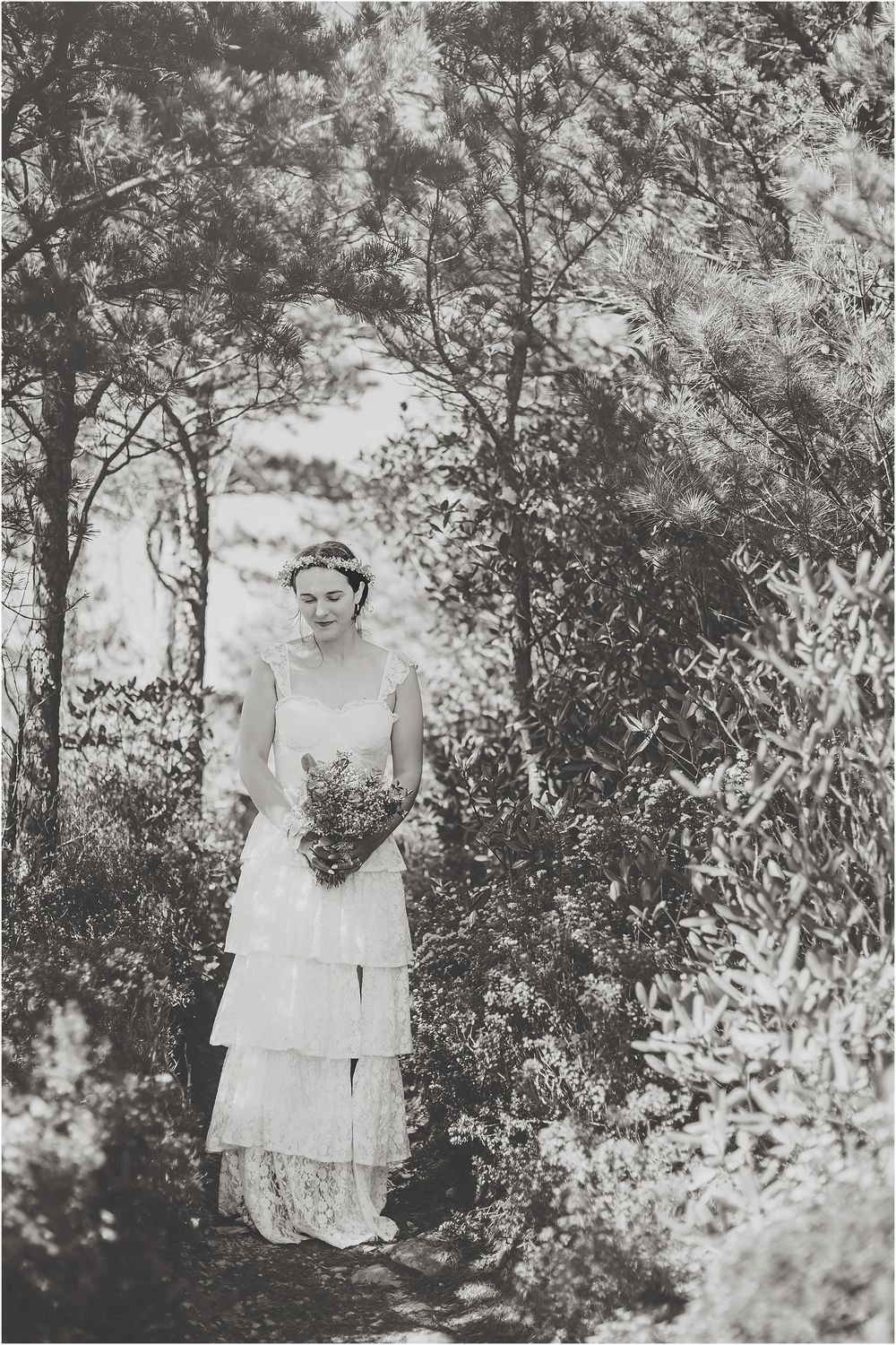 Black and white wedding portraits taken among trees and natural foliage.