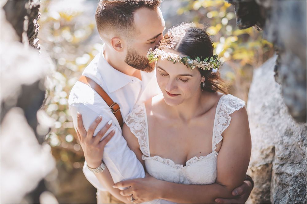 Romantic wedding portraits with golden sunlight filtering through autumn foliage.