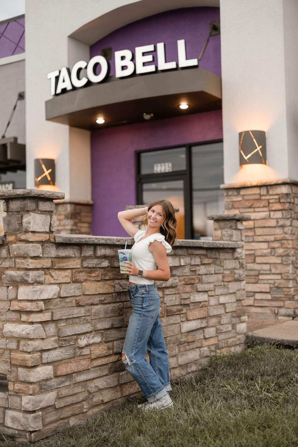 Series of photos showing stone columns and exterior signage of a Taco Bell restaurant at dusk.